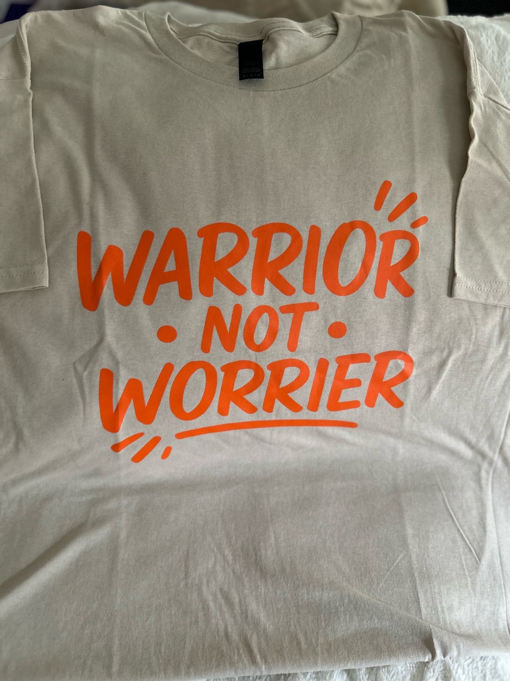 Women’s Cream Tee with Orange 'Warrior Not Worrier' Graphic